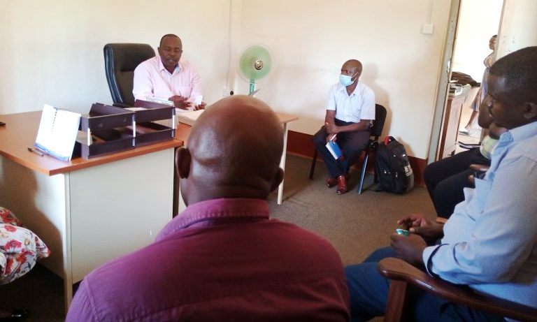 DHO Luuka District, Dr. Wandira chairs a debrief DHT meeting with COMONETH team at his office after field work